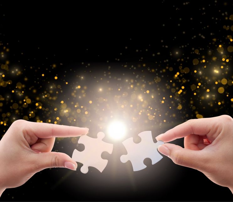 Two shiny puzzle pieces representing corporate innovation fit